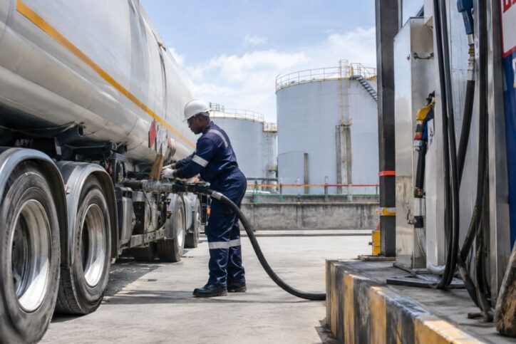 A man dispensing diesel in a tanker.
